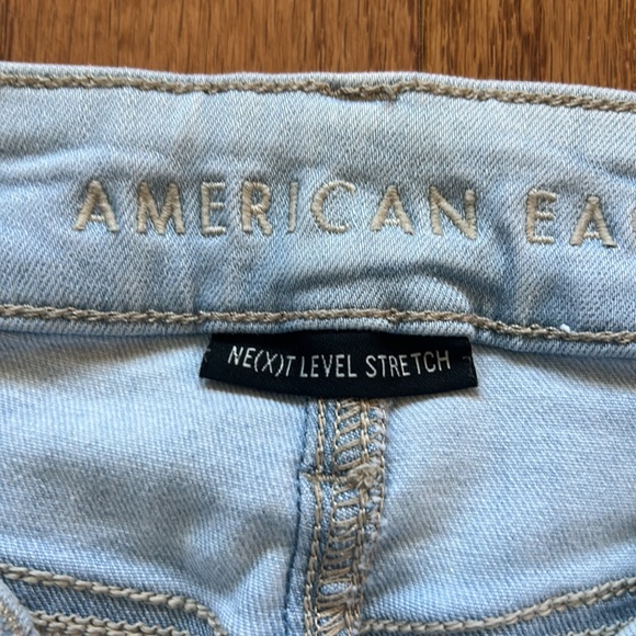 AMERICAN EAGLE NEXT LEVEL STRETCH DISTRESSED ROW HEM MID RISE LIGHT BLUE SIZE 00 - Picture 5 of 6